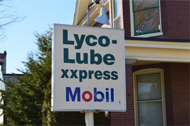 Lyco Lube XXpress sign next to a brick house in Williamsport, PA.