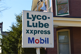 Lyco Lube XXpress sign next to a brick house in Williamsport, PA.