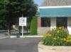 Lyco Lube XXpress sign and parking lot next to a bed of green and yellow flowers in Williamsport, PA.